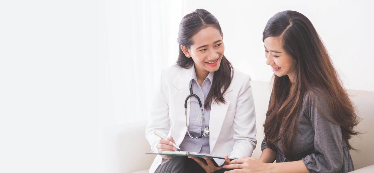 A client and clinician talking, both smiling